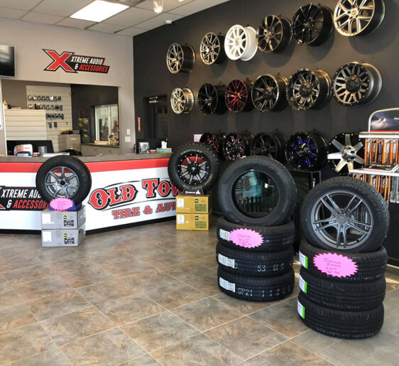 Old Town Auto reception area with rims and tires on display.